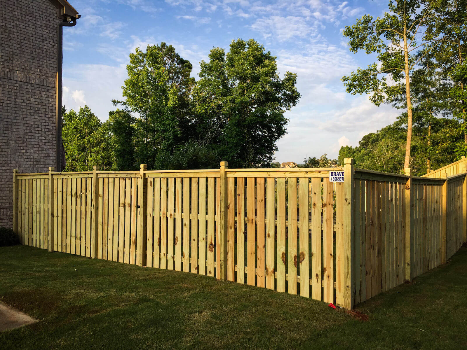 A solid cedar back yard fence built by Bravo