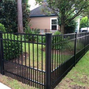 A black aluminum backyard fence